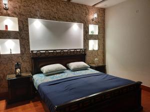 a bedroom with a bed with two pillows on it at Furnished Luxury Holiday and Vacation Home in Lahore