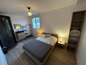 a bedroom with a bed and two shelves in it at Villa famille 4 chambres in Chandolas +56 photos