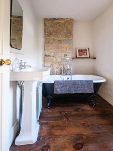 a bathroom with a bath tub and a sink at Bakewell cottage in Bakewell