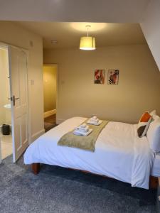a bedroom with a bed with two towels on it at Stunning River View in Mytholmroyd