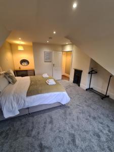 een slaapkamer met een groot bed en een open haard bij Stunning River View in Mytholmroyd