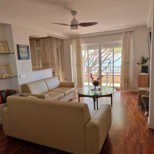 a living room with a couch and a table at Estepona playa in Estepona