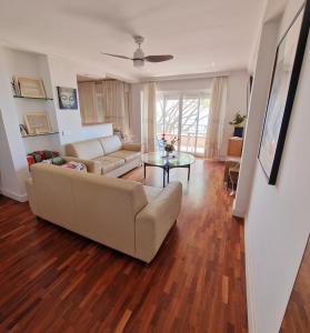 a living room with a couch and a table at Estepona playa in Estepona