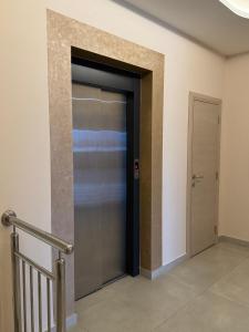 a elevator door in a building with a staircase at Kristal Garni Hotel in Novi Sad