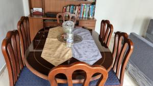 a dining room table with chairs and a glass tableablish at Casa Dohko in Bogotá