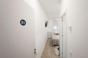 a white room with a door to a bedroom at Pension MD in San Sebastián