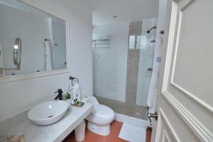 a white bathroom with a sink and a toilet at Hotel M Boutique in Villeta +20 photos