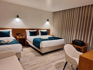 Postel nebo postele na pokoji v ubytování 3M Hostel & Suites