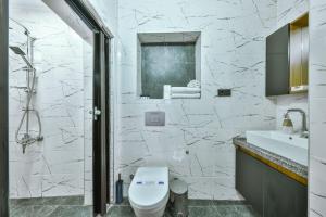 a white bathroom with a toilet and a sink at OnGalata in Istanbul