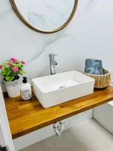 baño con lavabo blanco en una encimera de madera en Victoria Beach Premium, en Málaga