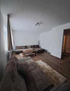 a living room with a couch and a coffee table at Apartment Iris bedroom living and parking voucher vacanță in Baia Mare