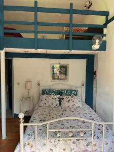 a bedroom with a blue and white bunk bed at La Faisanderie in Saint-Florent-sur-Cher