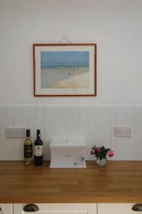 a picture of a beach with two bottles of wine at 10 Yards from Sea Hightide – Own Access to Beach in Sheringham