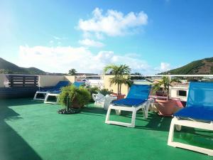a group of chairs sitting on a roof at Cole Bay Apartments nearby Marinas in Koolbaai