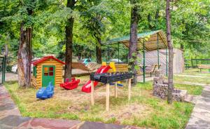 a playground with colorful play equipment in a park at Green Hotel in Abastumani