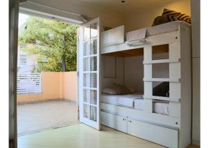 a bedroom with a bunk bed with a door open at Villa Hostel SP - Próximo ao Allianz Parque e Paulista in Sao Paulo