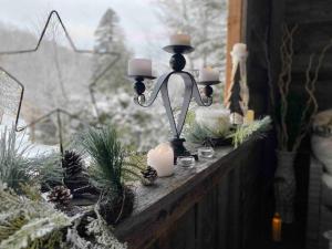 a table with candles and christmas decorations on it at Cozy Chalet by lake & Nature in Saint-Raymond