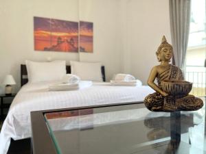 a statue sitting on a glass table next to a bed at Boutique At Historic Centrum 2 in Ioannina