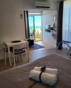 a living room with a bed and a table with a towel at Blue Star Apartments in Dubrovnik