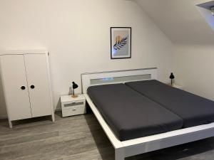 um quarto com uma cama e um armário branco em TraumAppartment em Mönchengladbach