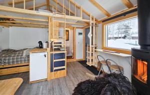 a tiny house with a kitchen and a bunk bed at Cozy Home In Gol With Sauna in Golsfjellet