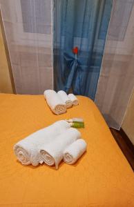 a group of towels are sitting on a bed at Wanderlust Pietralata B&B in Rome