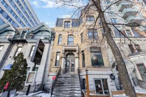 a large brick building with stairs in front of it at LiV MTL Downtown in Montréal