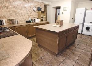 a kitchen with an island in the middle of a kitchen at Penbryn Mynach Holiday Cottage in Barmouth