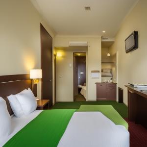 a hotel room with a large bed and a bathroom at Hotel Spiritual Land in Mathura