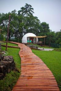 a red brick path leading to a white tent at Willkay Glamping Raco Tucumán in Tafí Viejo