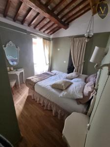 a bedroom with a bed and a window and a table at Vesionica Holiday House Perugia in Civitella Benazzone