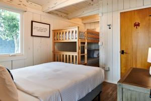 a small bedroom with a bed and bunk beds at Dillon Beach Resort in Dillon Beach