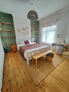 a bedroom with a bed and a bench in it at Sofia's Place - Entire 3bedroom house with mezzanine in Rugby