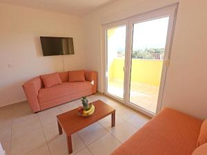 a living room with a couch and a table at SOLARIS ANTONELA Modern Apartments with Sea View & Free Private Parking in Sveti Filip i Jakov
