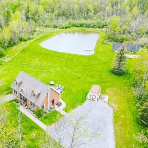 an aerial view of a house with a pond at Relaxing Retreat in the Heart of the Finger Lakes!- Dog Friendly and Hot tub in Springwater