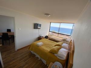 a bedroom with a bed with a view of the ocean at Deptos en Iquique, Chile, frente a Playa Brava in Iquique