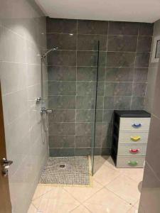 een douche met een glazen deur in de badkamer bij Appart familial chic & confort in Kenitra