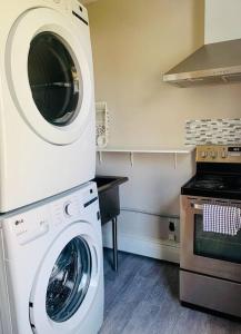 a kitchen with a washing machine and a stove at Quiet Studio #1 in Halifax