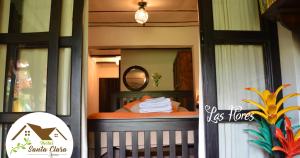 a small bedroom with a bed and a mirror at Hostal Santa Clara B&B in Apaneca