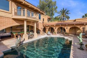a house with a swimming pool in the middle of a yard at Ethereal Corner Ritz Carlton Grand Estate Golf Mountains Jacuzzi Sauna Theater Gym in Scottsdale