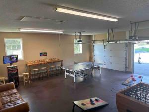 a room with two ping pong tables in a room at Bears Valley Inn -Peaceful, Pet Friendly Family Getaway, Less than 15 min to Attractions, with Game Room, Fire Pit & BBQ, Easy, Flat Roads in Sevierville