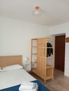 a bedroom with a bed and a wooden book shelf at Casa di Corte a Milano in Milan