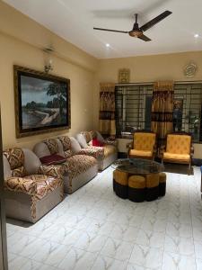 a living room with couches and a coffee table at Holiday home in Sylhet (Kasobir) in Kilsby