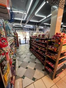 a store aisle of a grocery store with food at Pousada Família in Santo Antônio do Pinhal