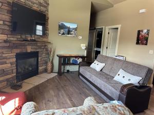 a living room with a couch and a fireplace at Sweet Pea in Red Lodge