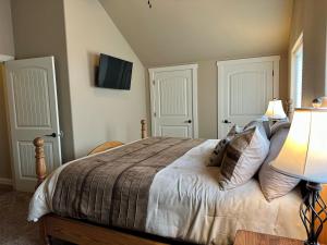 a bedroom with a bed with two white doors at Sweet Pea in Red Lodge