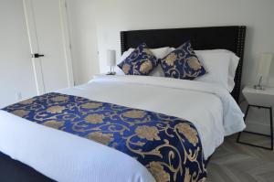 a bed with a blue and gold blanket and pillows at Dimond Abode Vacation Home 2 in Oakland