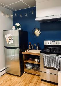 a kitchen with a refrigerator and a stove at Comfy Studio #3, Central Location, Parking in Halifax