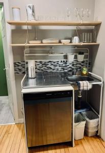a kitchen with a sink and a stove at Comfy Studio #3, Central Location, Parking in Halifax