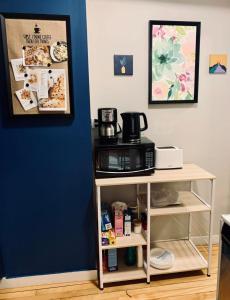 a kitchen with a microwave on a shelf next to a wall at Comfy Studio #3, Central Location, Parking in Halifax